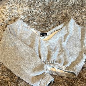 Wide, off the shoulder cropped grey sweatshirt